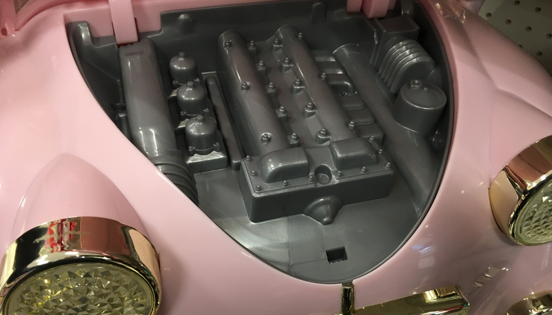Illustration for article titled This Very Pink Toy Ride-On Car Has A Surprisingly Specific Engine Design
